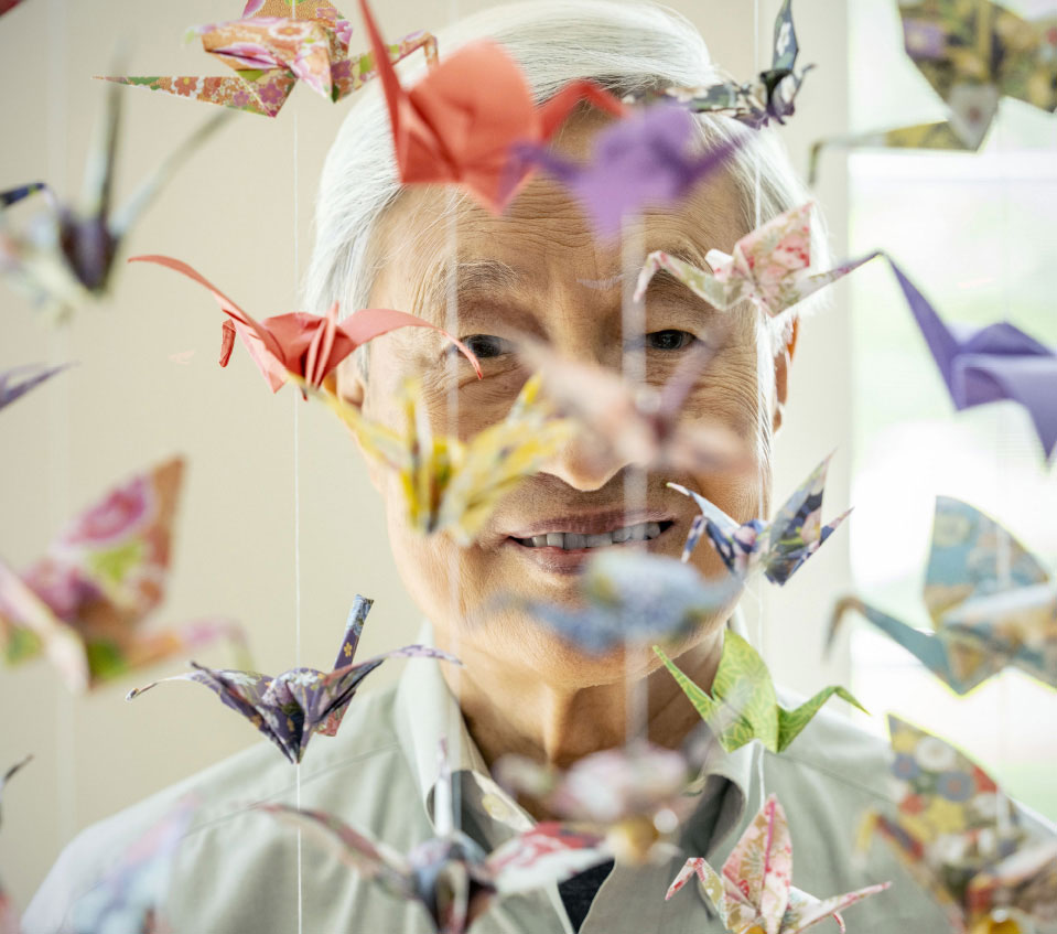 man behind origami swans