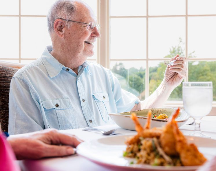 man holding fork at dinner